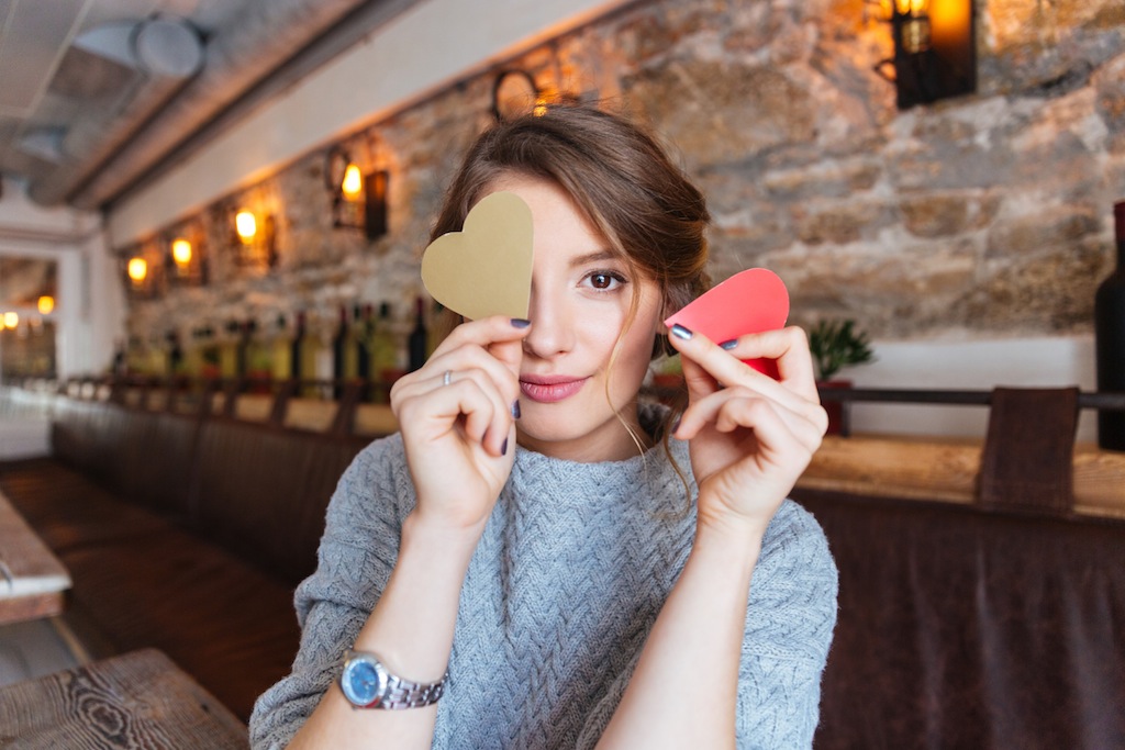 Happy woman holding red heart