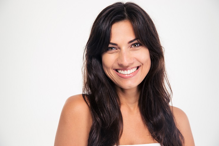 Beauty portrait of a smiling woman looking at camera isolated on a white background